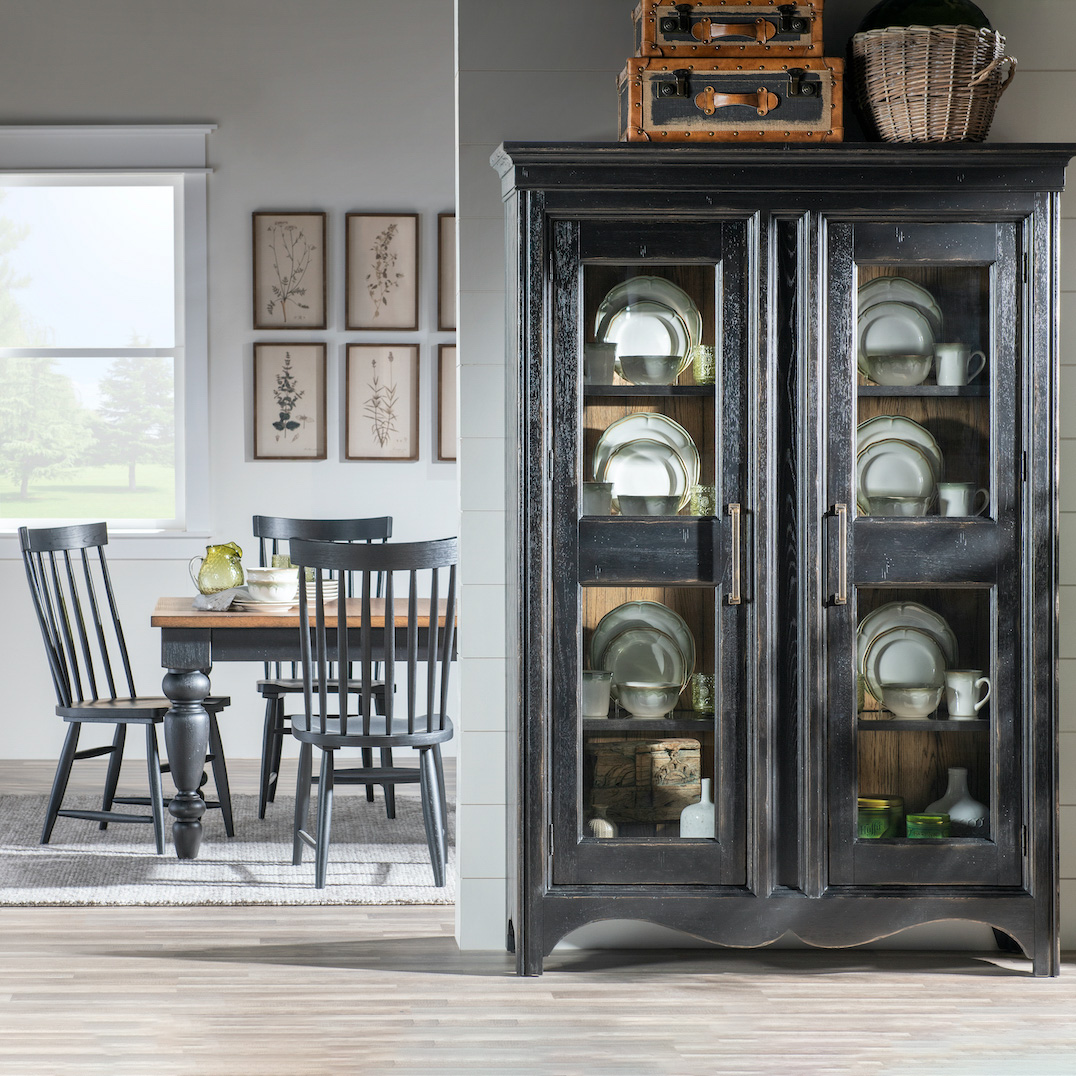Country armoire or hutch in a black finish in a dining room