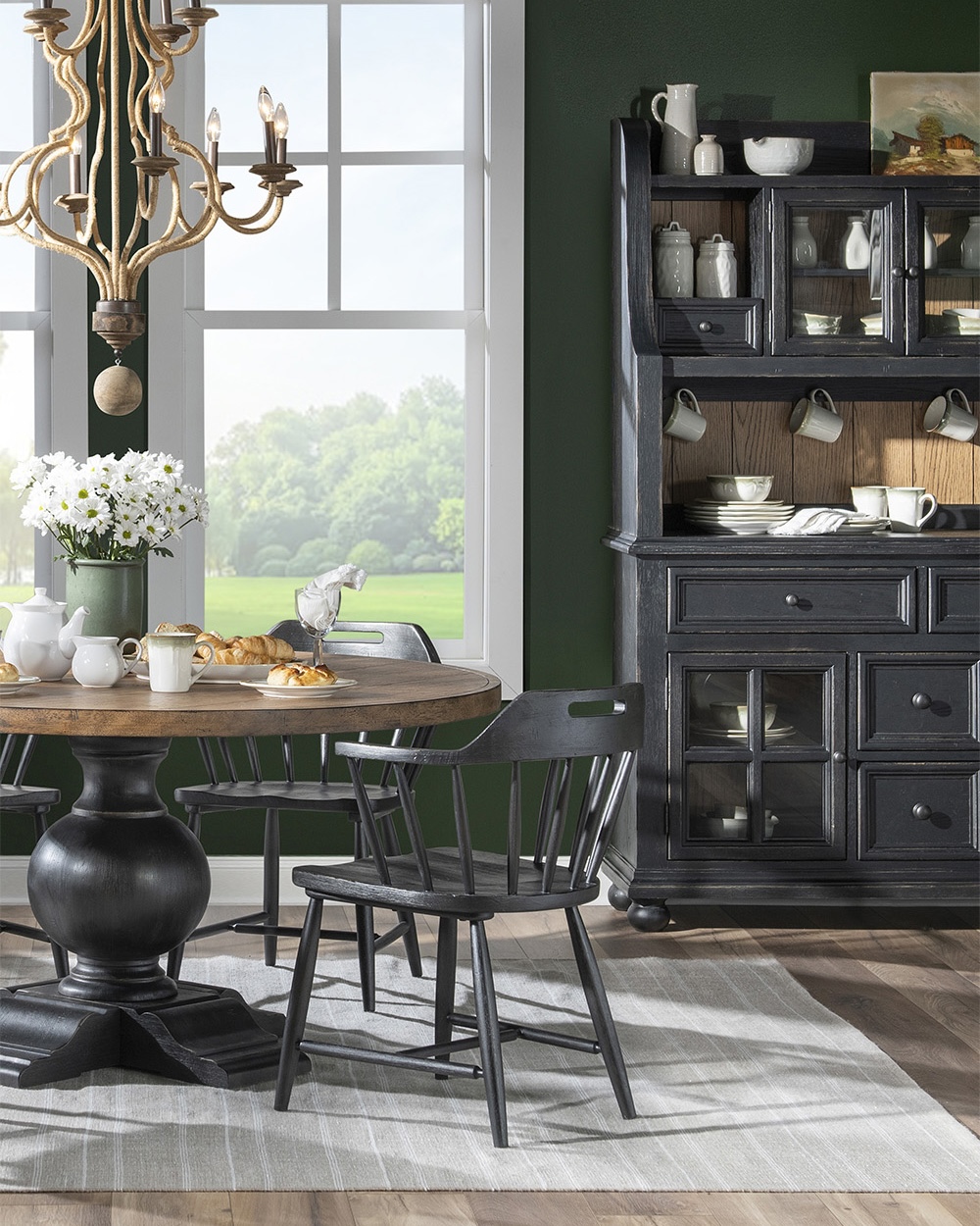Black base and wood top pedastal table with black chairs